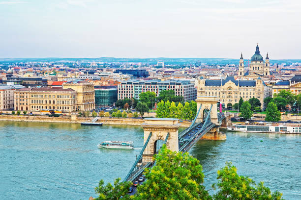 Chain Bridge above Danube Canal and St Stephen Basilica Budapest Chain Bridge above Danube Canal and St Stephen Basilica at Pest city center in Budapest, Hungary budapest danube river cruise hungary stock pictures, royalty-free photos & images