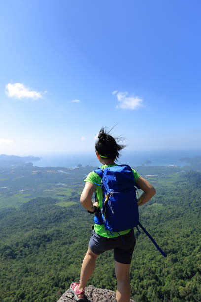 istock young woman backpacker enjoy the view on mountain peak 667458728