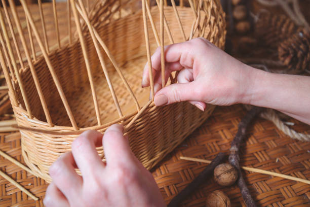 woman making basktes pretty woman making basktes indoor, handmade business basket weaving stock pictures, royalty-free photos & images