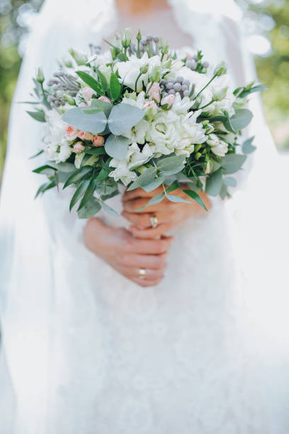 istock The bride hold wedding bouquet in hands 667466058