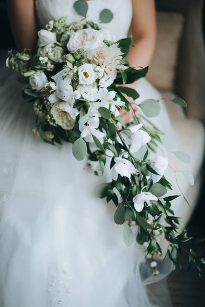 istock The bride hold wedding bouquet in hands 667466062