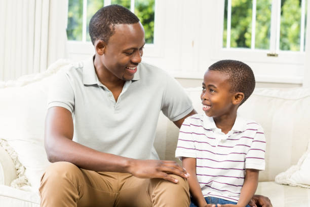istock Father and son sitting on the couch 667468468