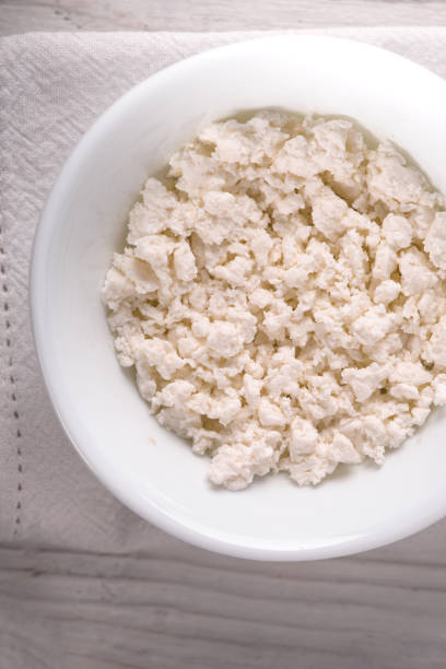 istock Cottage cheese in  ceramic plate on the white table vertical 667471506