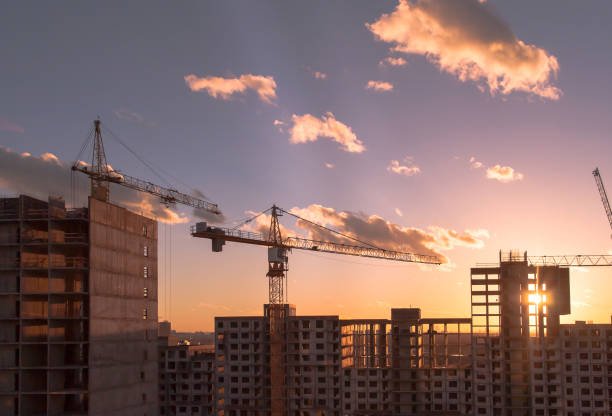 istock Construction of a residential complex at sunset 667472468
