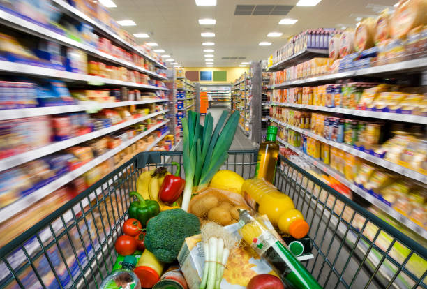 Shopping cart in the supermarket Shopping cart with foods at the grocery store fruit cart vendor stock pictures, royalty-free photos & images