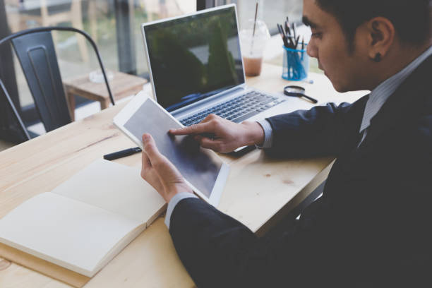 istock businessman watching something on digital tablet in office 667477728