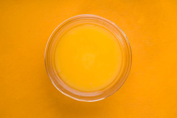 istock Honey on glass bowl on  yellow background top view 667482358