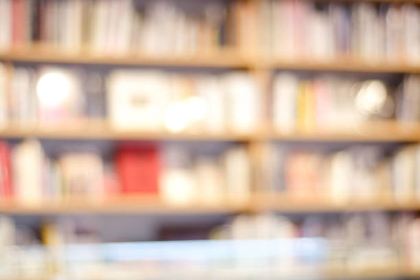 istock Blurred background, Blur bookshelves at book store background, education concept 667485310