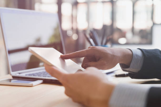 istock businessman watching something on digital tablet in office 667485336