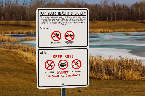 Warning signs around storm drainage pond Warning signs around storm drainage pond. Distracted stock pictures, royalty-free photos & images