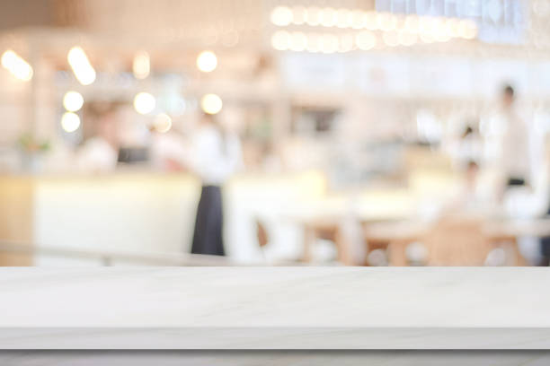 istock Empty white marble over blur cafe background, product and food display montage 667485922