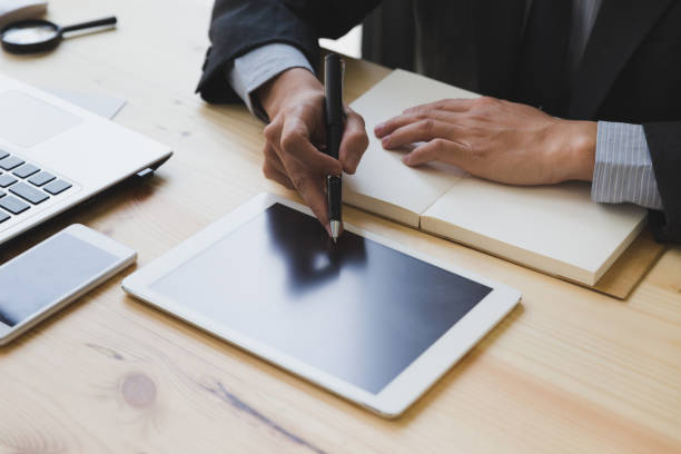 istock businessman watching something on digital tablet in office 667486154