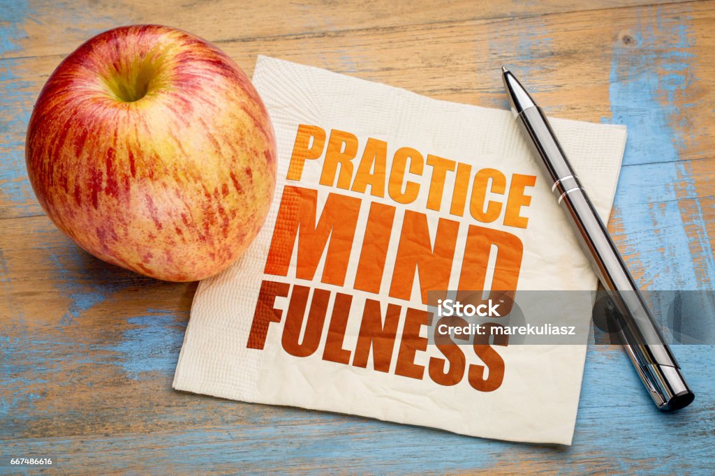 Practice mindfulness word abstract Practice mindfulness - motto or resolution on a napkin with an apple Mindfulness Stock Photo