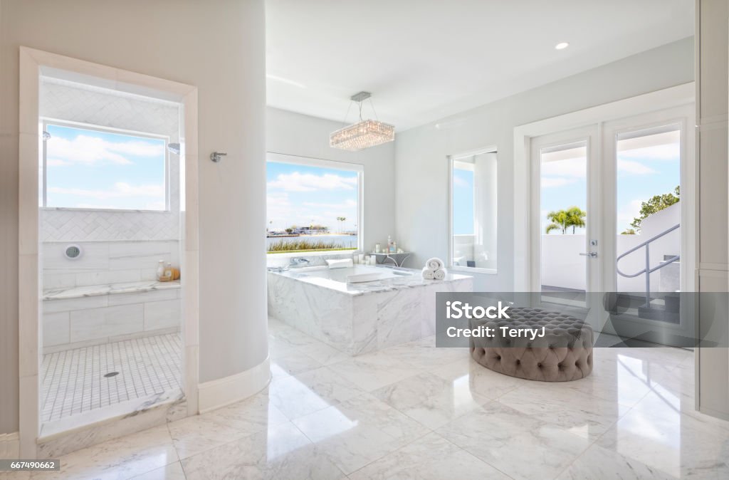 Regional Luxury Houses Beautiful Master Bathroom Interior with free standing bath tub surround by marble Marble - Rock Stock Photo