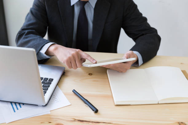 istock businessman watching something on digital tablet in office 667490700