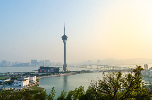 Modern urban skyscrapers in front of the Macau Cross Sea Bridge