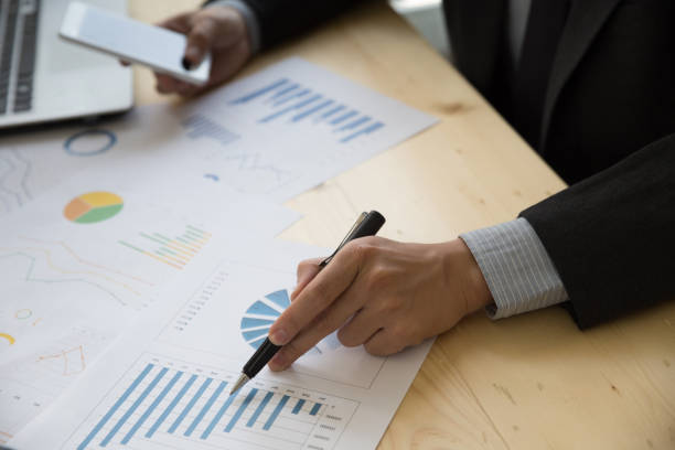 istock Businessman analyzing charts and graphs with smartphone. 667495488