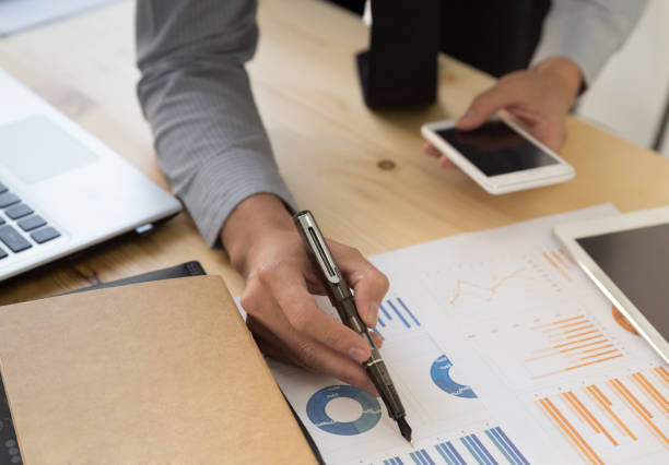 istock Businessman analyzing charts and graphs with smartphone. 667495986