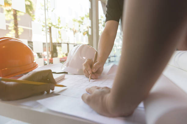 istock Architect or engineer meeting, working with blueprints in office, Construction concept. 667496180
