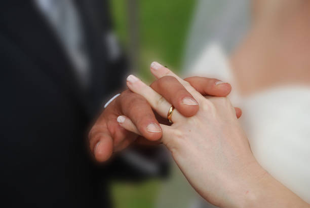istock hands of youngs married couple 667502864