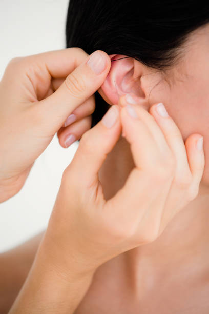 istock Woman holding a needle in an acupuncture therapy 667503364