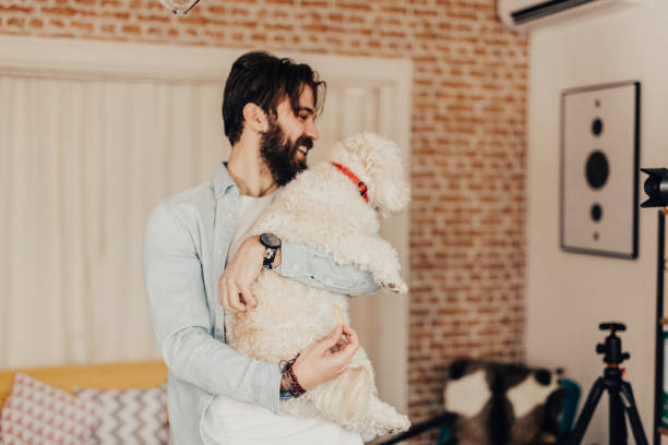 istock Bearded young adult is hugging his dog 667506428