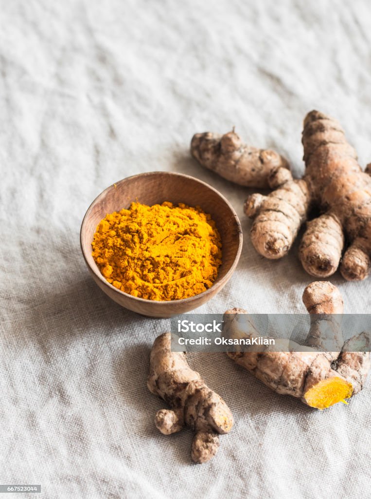 Turmeric root and turmeric powder on a light background Turmeric Stock Photo