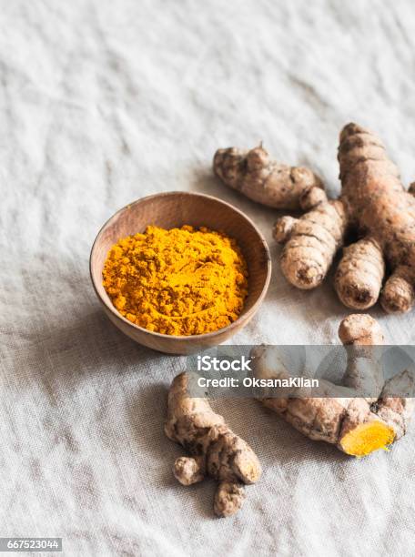 Turmeric Root And Turmeric Powder On A Light Background Stock Photo - Download Image Now