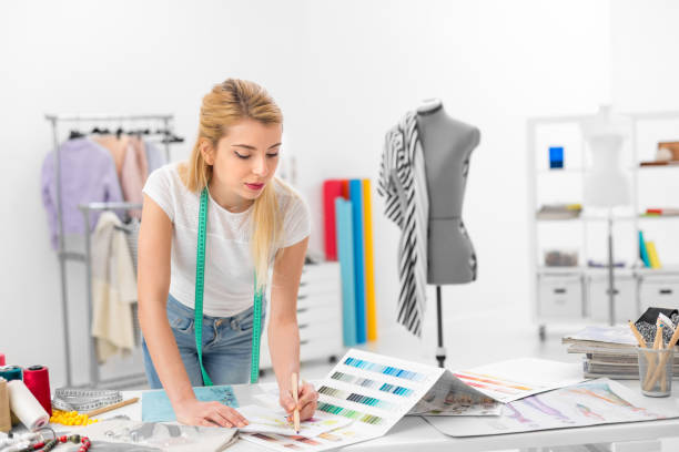 istock fashion designer colouring a sketch 667524190