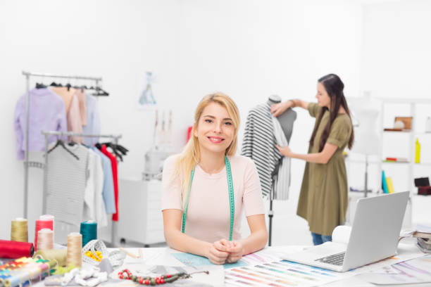 istock fashion designer sitting at desk 667524644