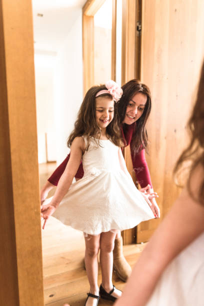istock mother and daughter dressing up at the mirror 667531374