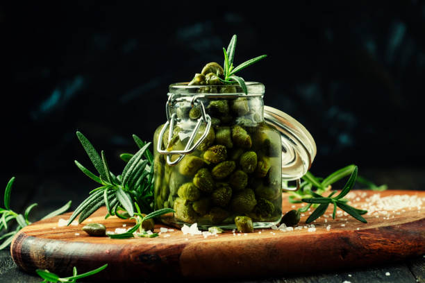 istock Capers with vinegar, salt and rosemary 667532176