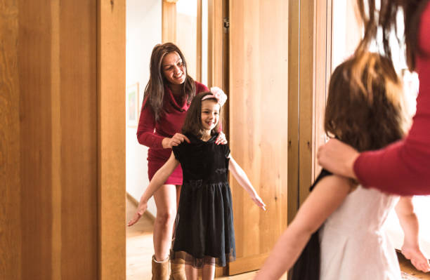 istock mother and daughter dressing up at the mirror 667532356