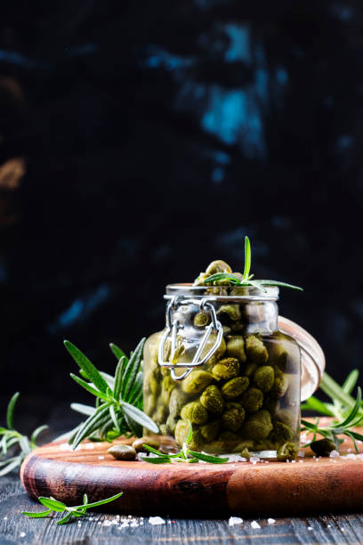 istock Capers with vinegar, salt and rosemary 667532944