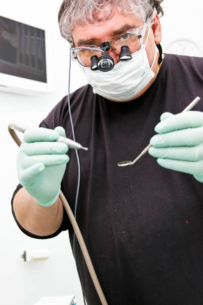 istock Dentist with special eyeglass a drill and angled mirror 667535338