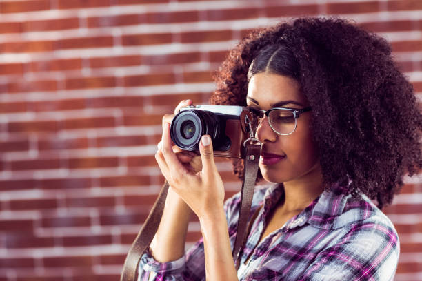 istock Attractive hipster photographing with camera 667539764