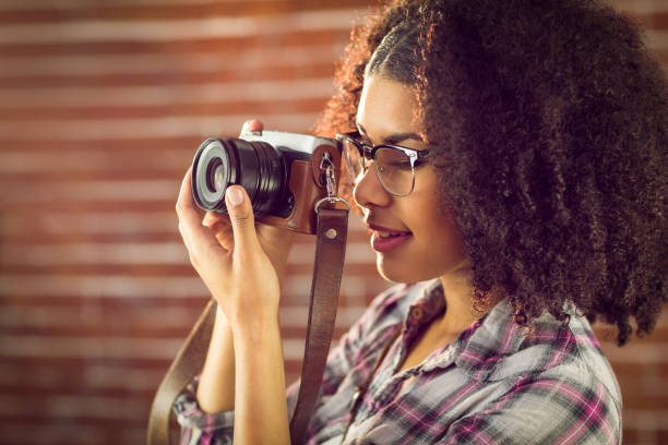 istock Attractive hipster photographing with camera 667539858