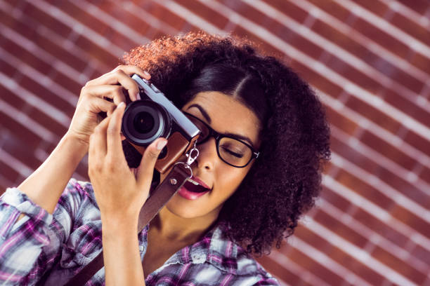 istock Attractive hipster photographing with camera 667540252