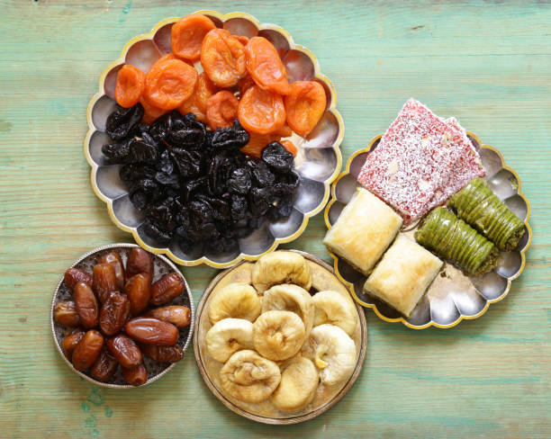 istock Eastern sweets (baklava, rahat loachum) and dried fruits on a silver plate 667540274
