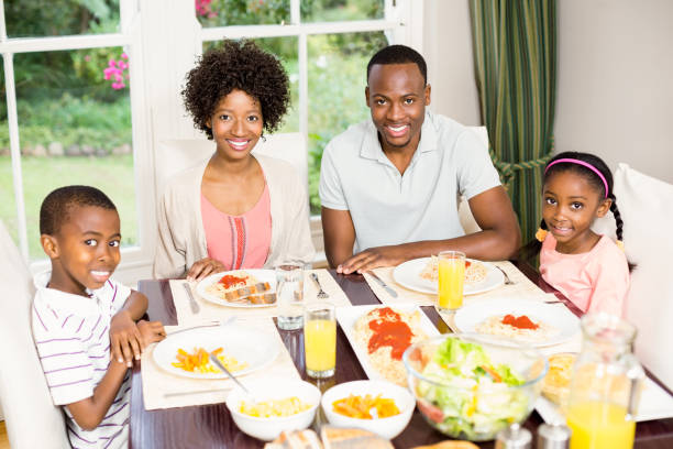 istock Happy family eating together 667540584
