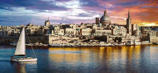 istock panoramic view of Valetta over sunset and with a sail boat. Malta 667542520