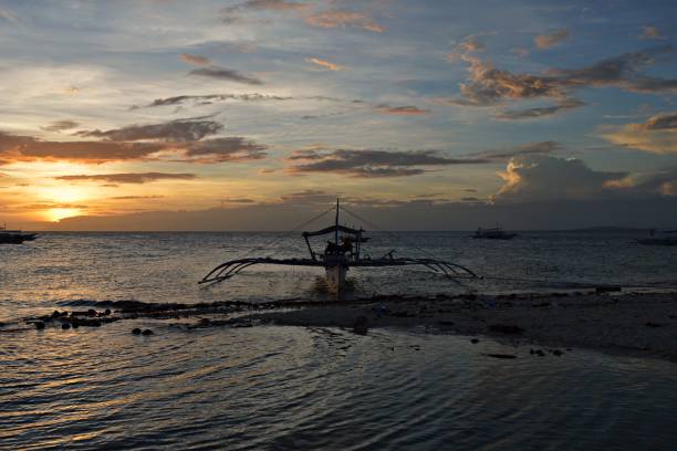Typical Bangka during sunset on the island Pamilacan in the Philippines stock photo