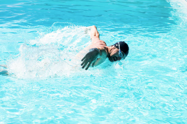 istock Fit swimmer doing the butterfly stroke 667547880