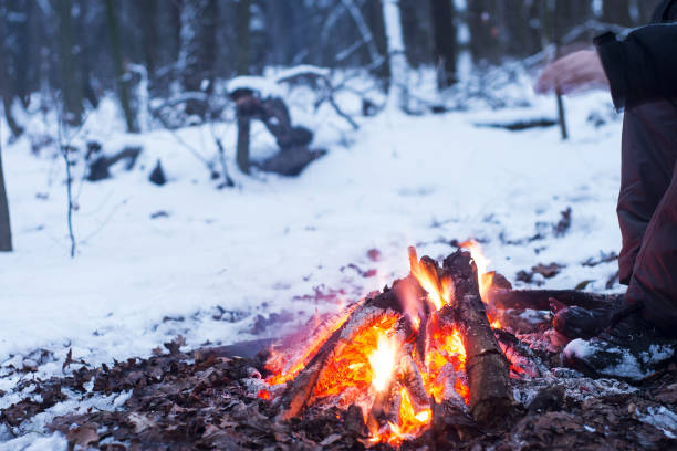 istock winter forest, the tourist warm tea in a pot, snow 667553696