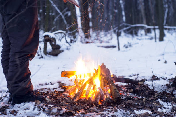istock winter forest, the tourist warm tea in a pot, snow 667553802