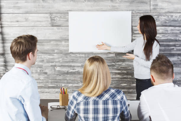 istock Pretty female showing whiteboard 667556772