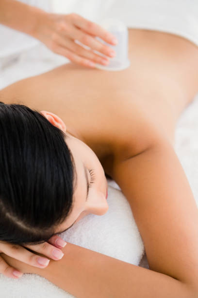 istock Beautiful brunette with vacuum cups on her back 667560432