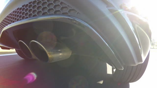 Driving fast at a sports track, view of exhaust pipe