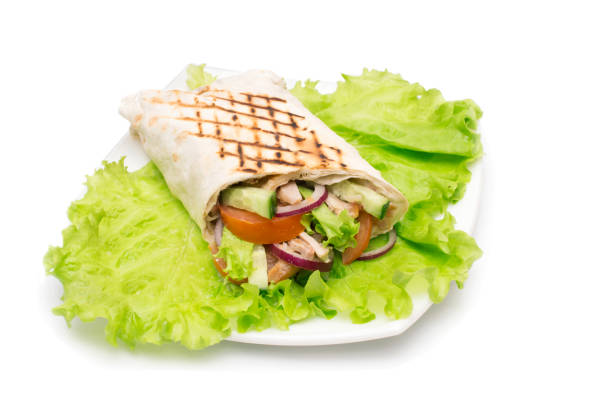 istock Shawarmas on lettuce isolated  a white background 667561688