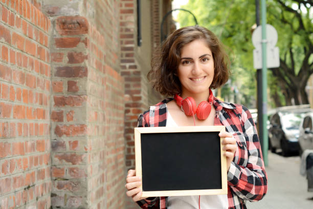istock Woman holding chalkboard. 667563894